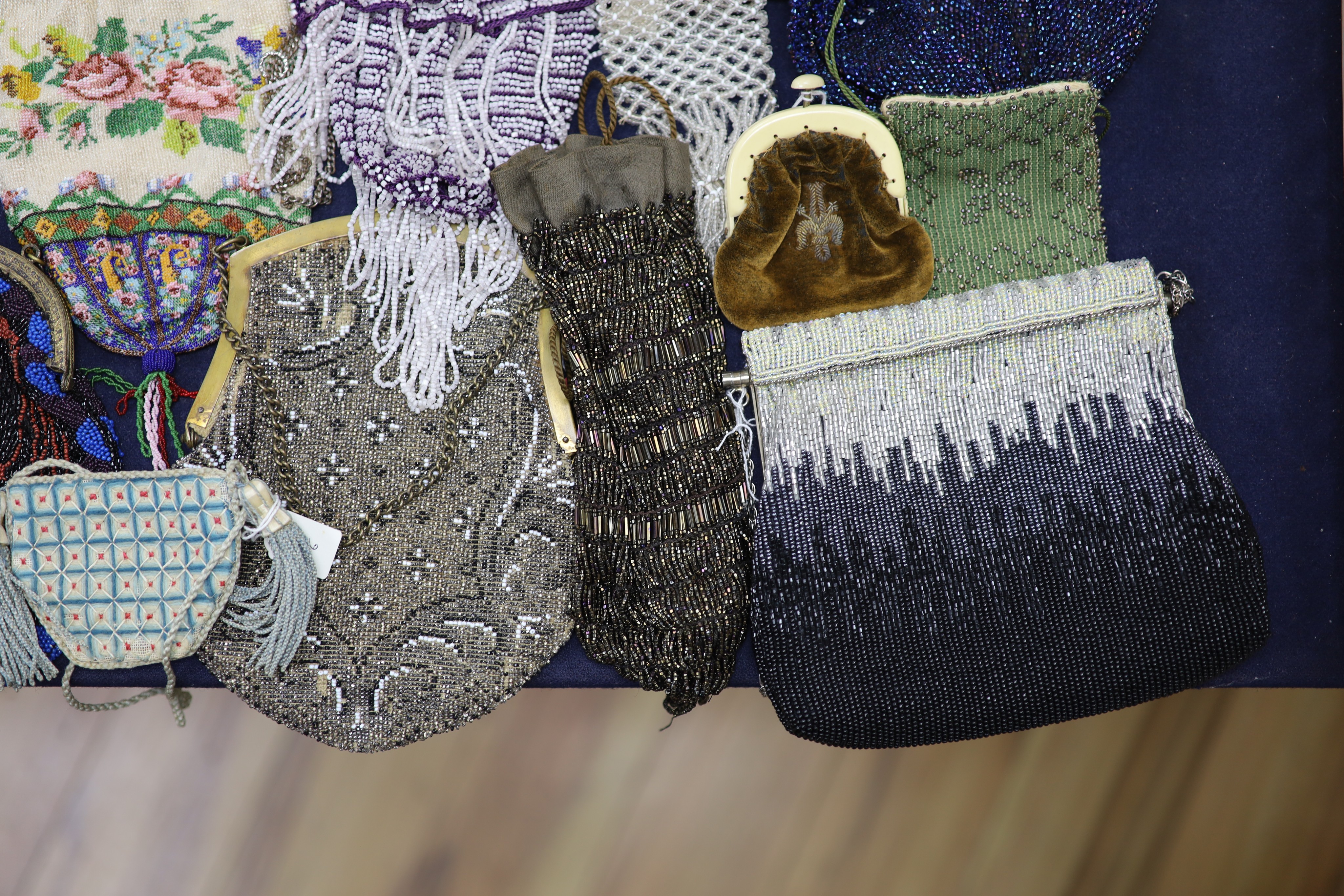 A collection of approximately fifty Victorian and later beadwork, white metal and fabric purses etc.